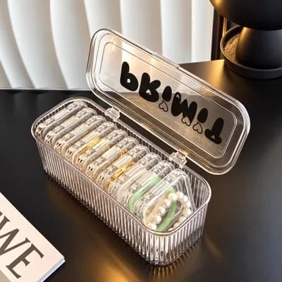 The case open, with ten small clear boxes standing in a row and “PRIMIT” printed on the lid
