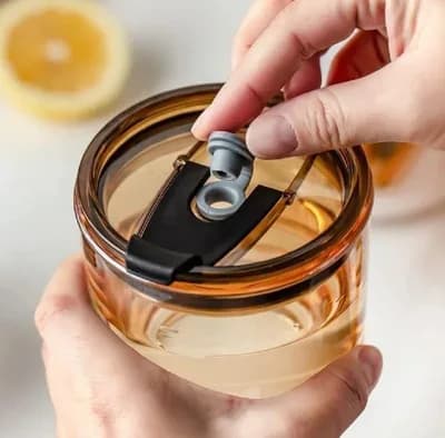 A hand opening the tumbler’s lid