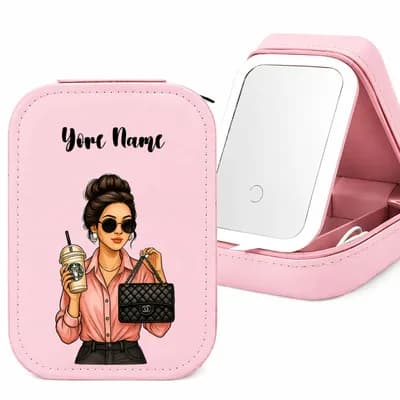 A pink makeup case printed with a woman in sunglasses holding an iced coffee and a black handbag, with a sample name above, beside the open case