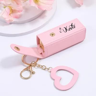 A pink case printed with the name Kate, with its key ring and heart charm