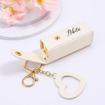 A cream case printed with the name Nikita, with its key ring and heart charm