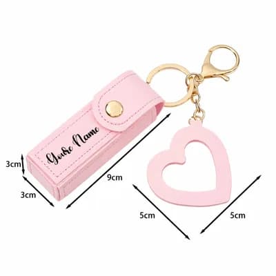 The pink case marked 9 cm long, 3 cm wide and 3 cm deep, and the heart charm 5 by 5 cm