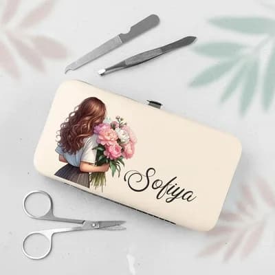 A cream case printed with a girl seen from behind holding a bouquet of pink peonies and the name “Sofiya”, beside nail scissors, a file and tweezers