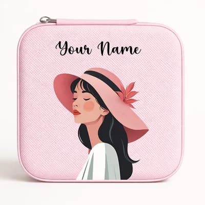 A pink mini jewelry box printed with a girl in a wide pink hat, her eyes closed, with “Your Name” above her