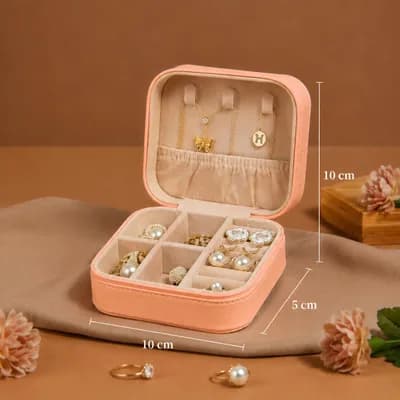 An open peach mini jewelry box holding jewelry, marked 10 cm wide, 10 cm deep and 5 cm tall