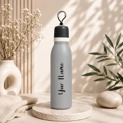 A matte gray water bottle with a black cap and carry loop, with “Your Name” printed along its side