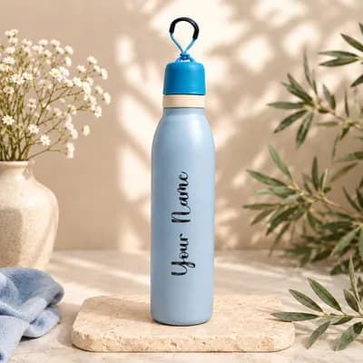 A powder blue water bottle with a blue cap and a black carry loop, with “Your Name” printed along its side