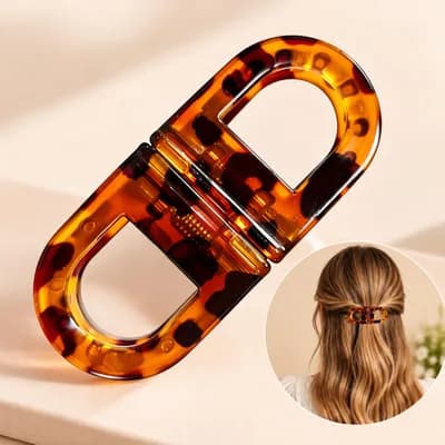 A tortoiseshell double-loop hair clip, and the clip holding a half-up style