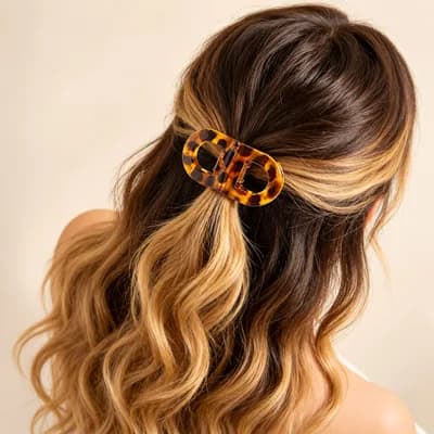 The clip holding back a section of long wavy hair